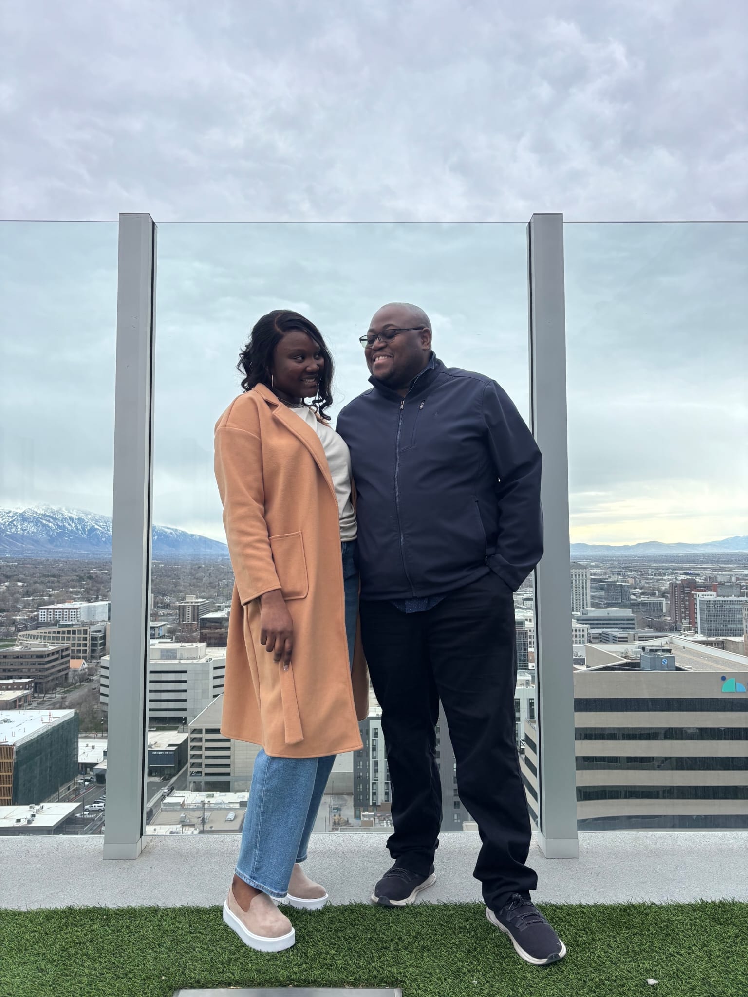 Jean-Philippe and Ketsia on a rooftop with city skyline