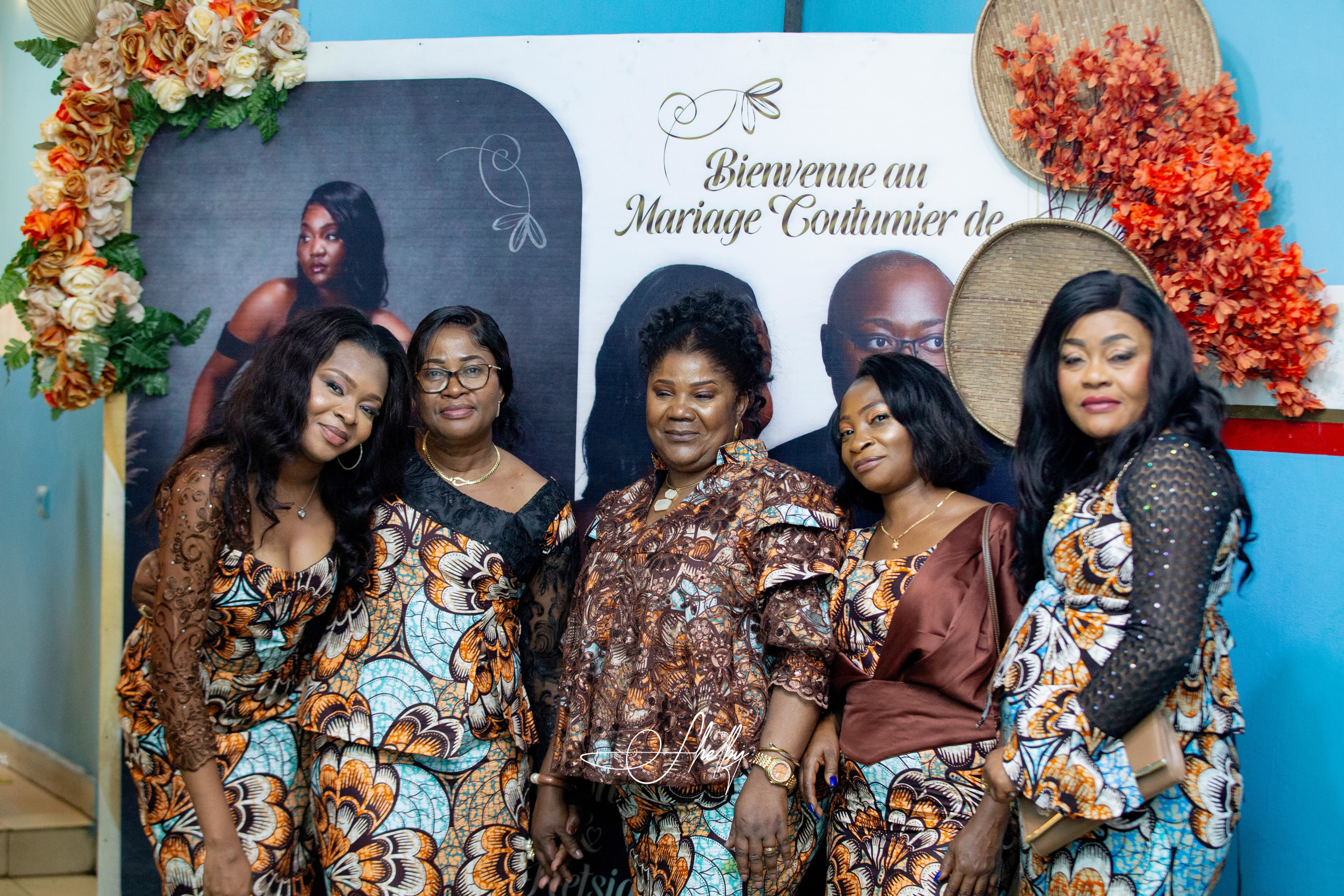 Women in vibrant African print attire at the traditional wedding of Jean-Philippe and Ketsia Matondo